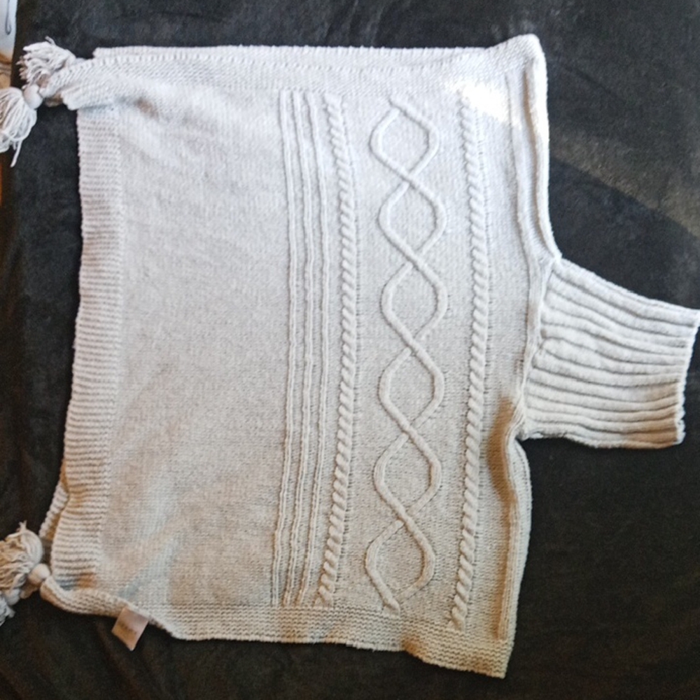 Serra 100% polyester grey knit turtle neck poncho with tassles